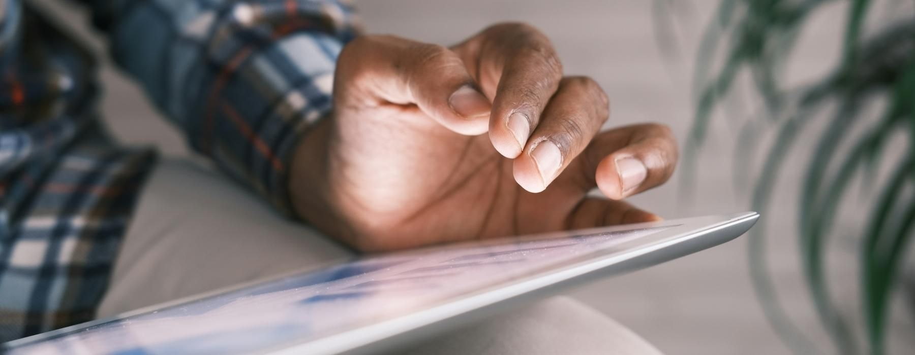 a person's hand on a tablet