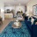 a living room with a blue rug